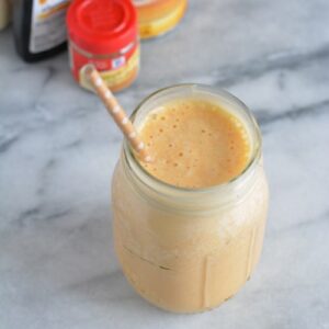 Pumpkin Pie Protein Shake with a brown and white polka dot straw.