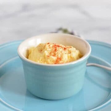 Pureed Classic Egg Salad in a blue ramekin on a blue plate.