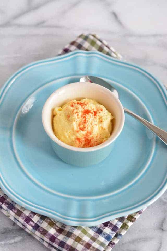 Pureed egg salad in a dish on a blue plate.