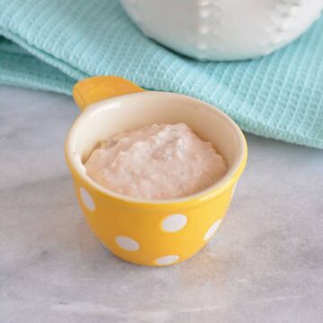 One serving of pureed tuna in a measuring cup.