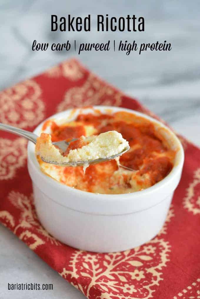 Baked Ricotta in a white bowl topped with marinara sauce.