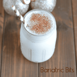 Protein shake in a mason jar topped with nutmeg.